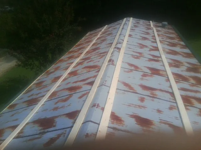 Rusted metal roof panels with new wood purlins before replacement — Storm Damage Roof Repair in Archie by Roofing Brothers